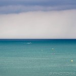 buoys and boats on stormy blue sea