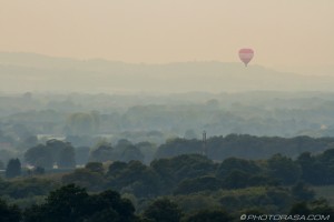 red air balloon over misty woodland