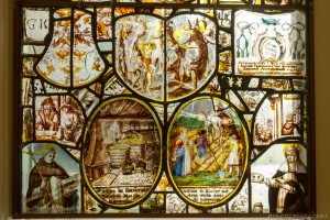 stained glass of farming scenes and rural workers