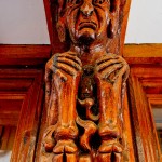 hooved pan carved into to wooden post