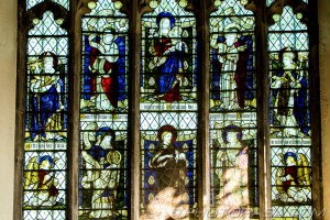 lady chapel stained glass window showing mary and baby jesus and saints