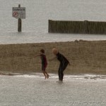 playing on the beach in a rainstorm