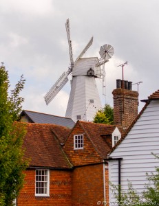 windmill raised above surrounding buildings