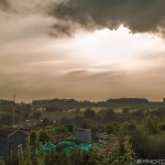 hazy sun and clouds over an allotment