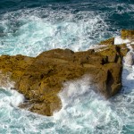 coastal rock engulfed by waves