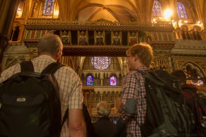 visitors observing the monuments in the presbytery