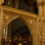 stone archway in front of organ pipes